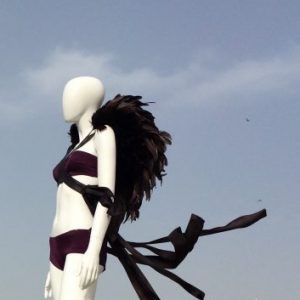 mannequin wears a bra top and underwear with feathered shoulder piece