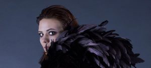 A model shows the feather details of the accessory.