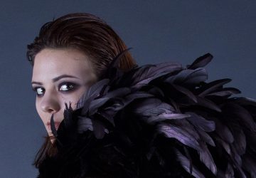 A model shows the feather details of the accessory.