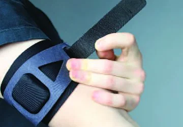 A model tightens an armband.