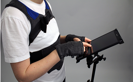 person in harness and gloves holding a tablet