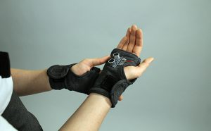 person wearing fingerless gloves with integrated technology