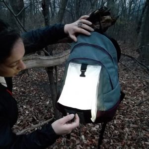 Hands activate the light in a backpack prototype