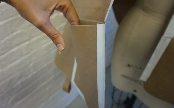 A hand opens a pocket in a design mockup.