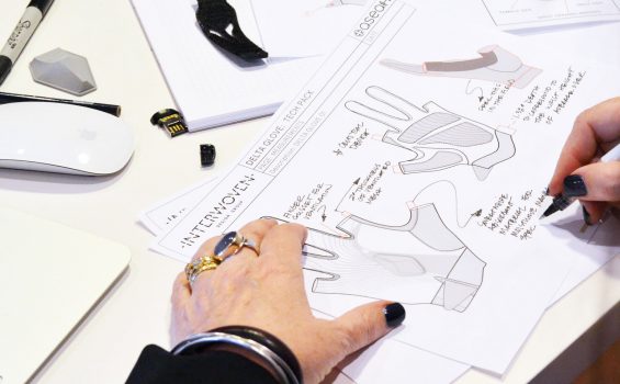 a designer annotates delta glove technical drawings