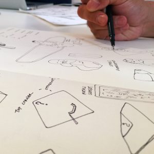 designer with pen drawing industrial design sketch