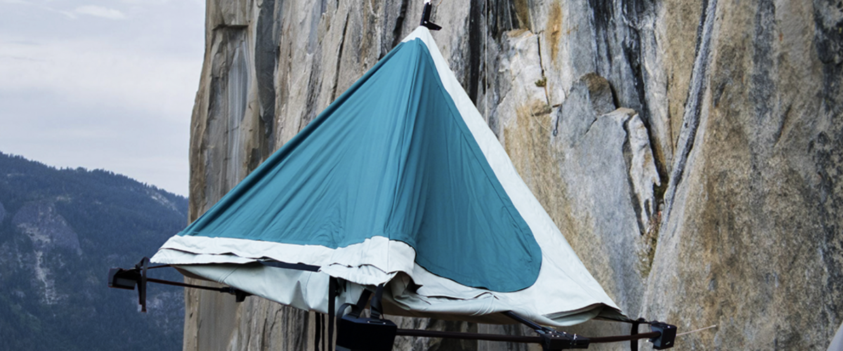 blue climbers camp tent on a cliff face