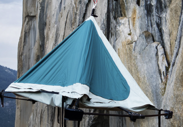 blue climbers camp tent on a cliff face