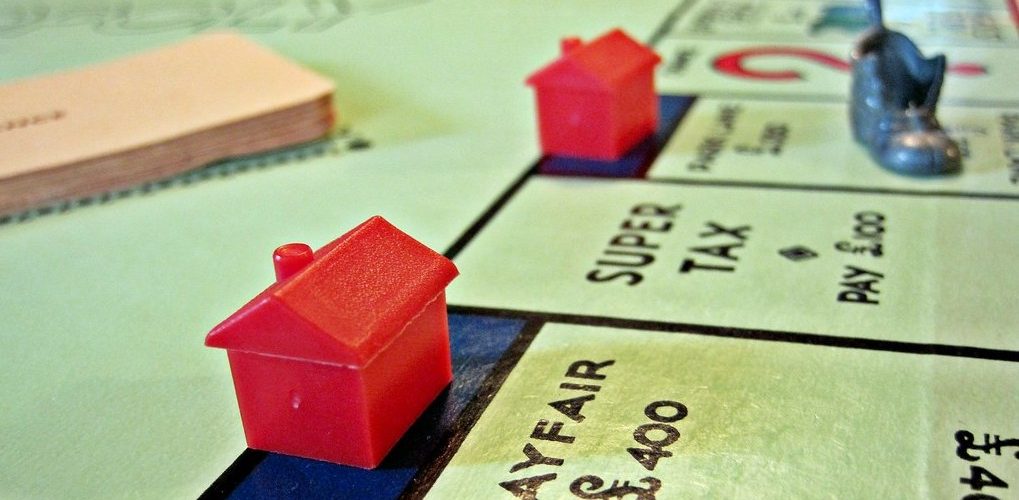 Red Houses dot a British Monopoly board